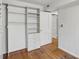 Walk-in closet with custom shelving and storage leading to a door; hardwood flooring at 702 Argonne Ne Ave # 1, Atlanta, GA 30308
