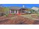 Well-maintained backyard with covered patio, stone pathway, and freshly manicured landscaping at 1112 Autumn Glen Way, Dacula, GA 30019