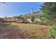 Expansive backyard featuring lush greenery, a stone walkway, and a cozy covered patio at 1112 Autumn Glen Way, Dacula, GA 30019