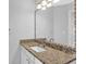 Bathroom featuring granite countertops, modern fixtures, and a decorative mirror at 1112 Autumn Glen Way, Dacula, GA 30019