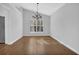 Dining room featuring wood floors, a chandelier, and large windows, perfect for gatherings at 1112 Autumn Glen Way, Dacula, GA 30019