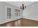 Dining area with hardwood floors, and a view of the outside from the large windows and door at 1112 Autumn Glen Way, Dacula, GA 30019