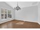 Dining room showcasing a chandelier, wood floors, and ample natural light at 1112 Autumn Glen Way, Dacula, GA 30019