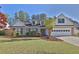 Charming single-Gathering home featuring a manicured front lawn, brick accents, and an attached two-car garage at 1112 Autumn Glen Way, Dacula, GA 30019