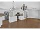 Open kitchen and dining area with stainless appliances, granite countertops, and ample cabinet space at 1112 Autumn Glen Way, Dacula, GA 30019