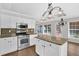 Bright kitchen with granite countertops, stainless appliances, and a functional island at 1112 Autumn Glen Way, Dacula, GA 30019