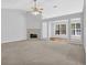 Open-concept living room features a fireplace and large windows that fill the space with natural light at 1112 Autumn Glen Way, Dacula, GA 30019