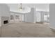 Bright living room with fireplace, large windows, neutral colors, and vaulted ceiling at 1112 Autumn Glen Way, Dacula, GA 30019