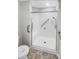 A white tiled accessible shower with a glass door is showcased in this bathroom at 2252 Carefree Cir # 3, Marietta, GA 30062