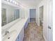 A long vanity with dual sinks is featured in this bathroom, along with tile flooring at 2252 Carefree Cir # 3, Marietta, GA 30062