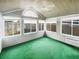 A sun room features large windows, vaulted ceiling, and bright green carpet at 2252 Carefree Cir # 3, Marietta, GA 30062