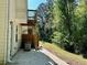 The home has a quaint back patio with a backyard space surrounded by mature trees, perfect for relaxation at 2939 Stonecrest Ln, Lithonia, GA 30038