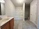 Bright bathroom featuring a white vanity, tiled floor, and tub with shower at 2939 Stonecrest Ln, Lithonia, GA 30038