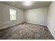 Cozy bedroom with neutral carpet and soft grey walls with natural light at 2939 Stonecrest Ln, Lithonia, GA 30038