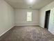 Bedroom with neutral carpet, grey walls, natural light through the window at 2939 Stonecrest Ln, Lithonia, GA 30038