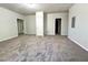 Bedroom with neutral carpet, grey walls, and hallway entrances at 2939 Stonecrest Ln, Lithonia, GA 30038