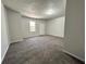 Spacious bedroom with neutral carpet, soft gray walls, and a window at 2939 Stonecrest Ln, Lithonia, GA 30038