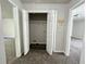 Hallway closet with bi-fold doors, wire shelves, and carpeted flooring at 2939 Stonecrest Ln, Lithonia, GA 30038