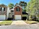 This townhome boasts brick accents, a single-car garage, and a well-maintained front lawn at 2939 Stonecrest Ln, Lithonia, GA 30038