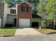 Charming townhome featuring brick accents, well-kept landscaping, and a convenient single-car garage at 2939 Stonecrest Ln, Lithonia, GA 30038