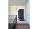 Inviting front entry with a black door, decorative light fixture, and classic design at 2939 Stonecrest Ln, Lithonia, GA 30038