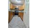 Well-lit kitchen with wooden cabinets, stainless steel microwave and oven, and neutral countertops at 2939 Stonecrest Ln, Lithonia, GA 30038
