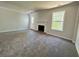 Bright living room featuring new carpet, a fireplace, and generous sunlight at 2939 Stonecrest Ln, Lithonia, GA 30038