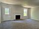 Spacious living room with fireplace, new carpet, and ample natural light at 2939 Stonecrest Ln, Lithonia, GA 30038