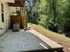 Concrete patio overlooking backyard area surrounded by mature trees at 2939 Stonecrest Ln, Lithonia, GA 30038