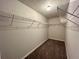 Spacious walk-in closet offers ample storage with shelving and cozy carpeted flooring at 2939 Stonecrest Ln, Lithonia, GA 30038