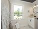 Well-lit bathroom featuring stylish tile floor, modern vanity, and a serene window view at 3365 Ardley Sw Rd, Atlanta, GA 30311