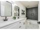 Sleek bathroom with dual sinks, modern fixtures, and tiled shower, offering both style and functionality at 3365 Ardley Sw Rd, Atlanta, GA 30311