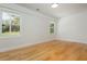 Sunlit bedroom showcasing hardwood floors, fresh white walls, and ample natural light through large windows at 3365 Ardley Sw Rd, Atlanta, GA 30311
