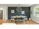 Charming dining room showcasing a decorative accent wall, modern light fixture, and seating for six at 3365 Ardley Sw Rd, Atlanta, GA 30311