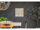 Stylish dining room featuring a wood table, modern light fixture, and accent wall with tree art at 3365 Ardley Sw Rd, Atlanta, GA 30311