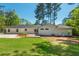 The backyard has a well-manicured lawn, patio, and lush landscaping, creating a serene outdoor oasis at 3365 Ardley Sw Rd, Atlanta, GA 30311
