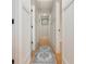 Hallway with hardwood floors, white paneled walls, decorative rug, and contemporary lighting at 3365 Ardley Sw Rd, Atlanta, GA 30311