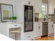 Modern kitchen with white cabinets, quartz countertops, and a built-in wine cooler for entertaining and enjoyment at 3365 Ardley Sw Rd, Atlanta, GA 30311