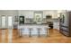 Open kitchen with white cabinets, stainless appliances, large island with seating, and hardwood floors at 3365 Ardley Sw Rd, Atlanta, GA 30311