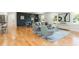 Open concept living room featuring hardwood floors, modern decor, and decorative accent wall at 3365 Ardley Sw Rd, Atlanta, GA 30311