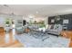 Open-concept living room flows into kitchen with hardwood floors and modern furniture at 3365 Ardley Sw Rd, Atlanta, GA 30311