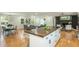 Open-concept living space with kitchen island, living room, and dining area with plenty of natural light at 3365 Ardley Sw Rd, Atlanta, GA 30311