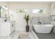 Elegant main bathroom featuring a modern soaking tub, sleek fixtures, and stylish marble accents at 3365 Ardley Sw Rd, Atlanta, GA 30311