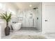 Luxurious main bathroom featuring a modern soaking tub, glass-enclosed shower, and sleek marble accents at 3365 Ardley Sw Rd, Atlanta, GA 30311