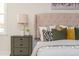 Close up of a main bedroom nightstand showing lamps, flowers, and a plush headboard at 3365 Ardley Sw Rd, Atlanta, GA 30311