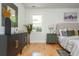 Bright main bedroom featuring hardwood floors, stylish furnishings, and an art piece depicting the city skyline at 3365 Ardley Sw Rd, Atlanta, GA 30311