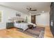 Spacious main bedroom with a plush bed, stylish decor, a ceiling fan and a modern sliding barn door at 3365 Ardley Sw Rd, Atlanta, GA 30311