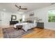 Bright and spacious main bedroom featuring hardwood floors, stylish furnishings, and a comfortable seating area at 3365 Ardley Sw Rd, Atlanta, GA 30311