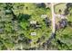 Aerial view showcases the property featuring the home and two sheds amidst lush greenery at 4301 Hidden Valley Rd, Decatur, GA 30035