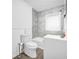 Bathroom features a clean white toilet and sink vanity, with modern marble-style tiles at 4301 Hidden Valley Rd, Decatur, GA 30035